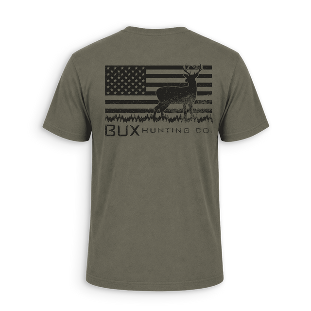 An olive green short-sleeve t-shirt shown from the back, featuring a distressed black graphic of a deer over an American flag with the text 'BUX HUNTING CO.' printed below.