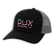A black trucker-style cap with a gray mesh back, featuring a red, white, and blue embroidered logo on the front that reads 'DUX WATERFOWL CO.' with an American flag motif.