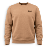 A tan crewneck sweatshirt with a small black cursive 'Dux' logo on the left chest, displayed on a clean white background.