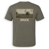 Back view of a green short-sleeved Dove shirt with a hunting scene graphic and the 'DUX' brand logo on the back

