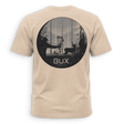 A beige crewneck t-shirt with a black graphic print on the back, featuring a circular hunting scene with a bowfied deer and the text 'BUX HUNTING CO.' in white, set against a solid green background.
