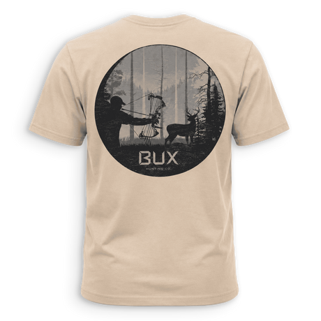 A beige crewneck t-shirt with a black graphic print on the back, featuring a circular hunting scene with a bowfied deer and the text 'BUX HUNTING CO.' in white, set against a solid green background.