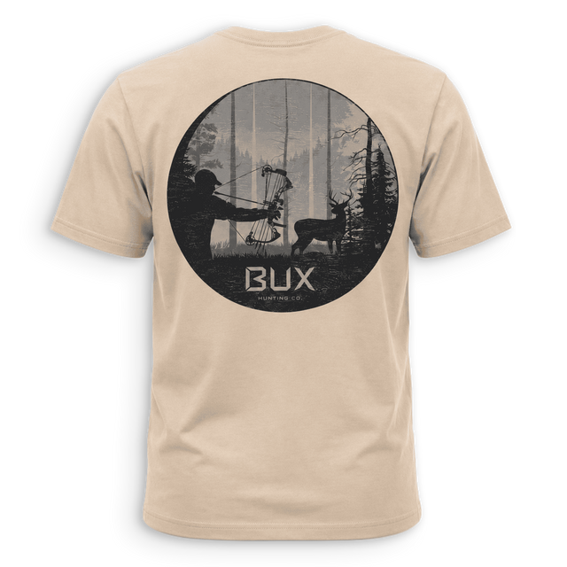 A beige crewneck t-shirt with a black graphic print on the back, featuring a circular hunting scene with a bowfied deer and the text 'BUX HUNTING CO.' in white, set against a solid green background.