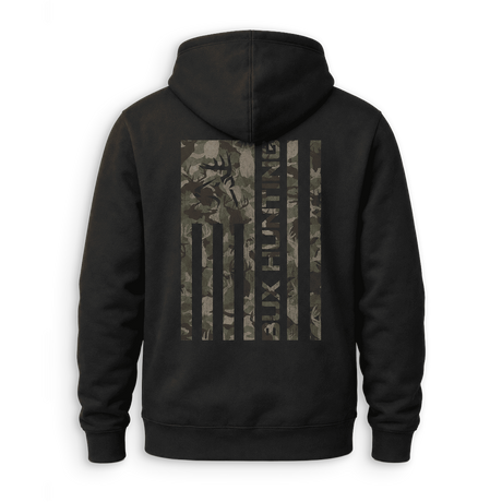 A black pullover hoodie shown from the back, featuring a large vertical American flag graphic on the back in a camouflage pattern with a deer head silhouette and the text 'BUX HUNTING'.