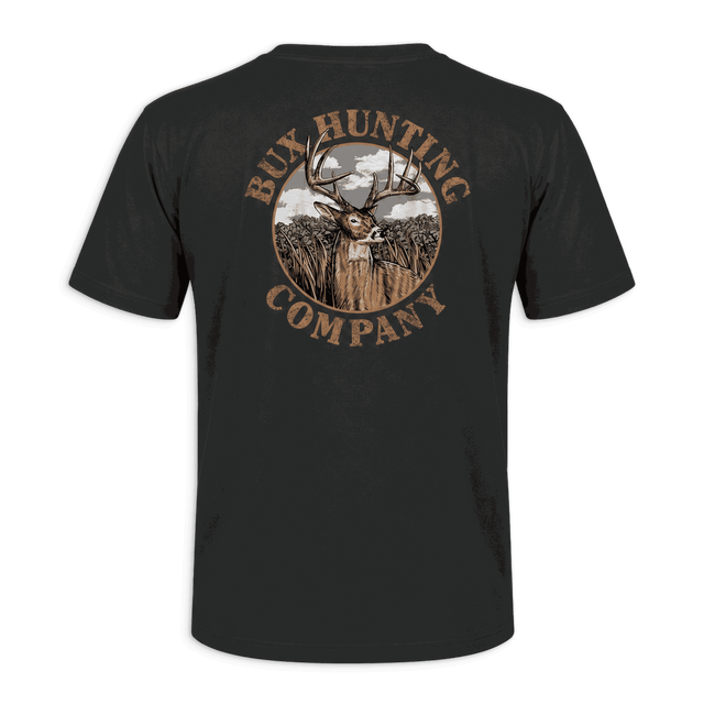 A black short-sleeve t-shirt shown from the back, featuring a large circular graphic print with a deer head, trees, and the text 'RUX HUNTING COMPANY' in brown and beige tones, set against a solid green background.