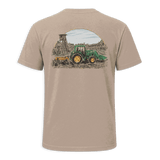 A beige short-sleeve t-shirt with black trim on the collar and sleeve cuffs, featuring a large graphic print on the back of a green tractor and a yellow combine harvester under a semi-circle sky.
