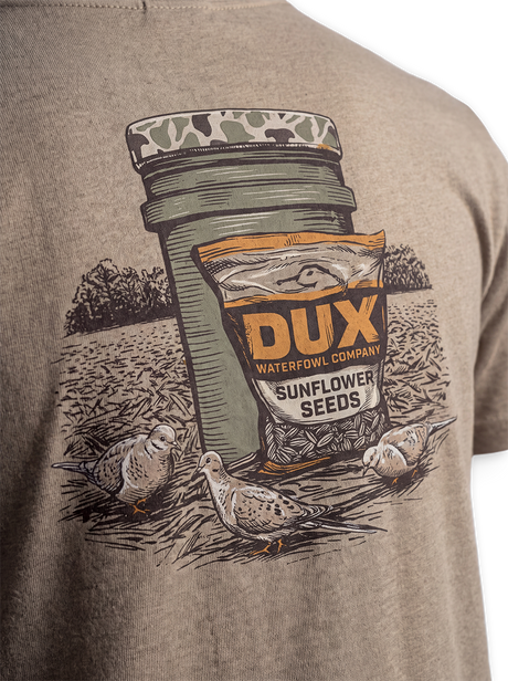 Close-up of the back artwork on a heathered taupe DUX shirt, featuring a Sunflower Seeds jar, bag, and three mourning doves.