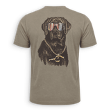 A short-sleeve crewneck t-shirt in a muted taupe-brown color, featuring a large graphic print of a black dog wearing sunglasses with an American flag pattern and a gold chain necklace with a gold 'P' pendant, shown on a clean white background.