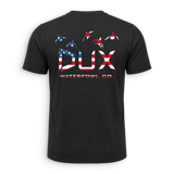 A black short-sleeve t-shirt shown from the back, featuring a large graphic print of the letters 'DUX' filled with an American flag pattern, with three waterfowl silhouettes above and 'WATERFOWL CO.' printed below.