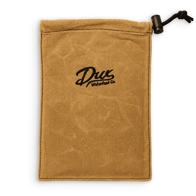 A tan canvas drawstring pouch with a black embroidered logo reading 'Dux Waterfowl Co.' in the center, shown on a plain white background.