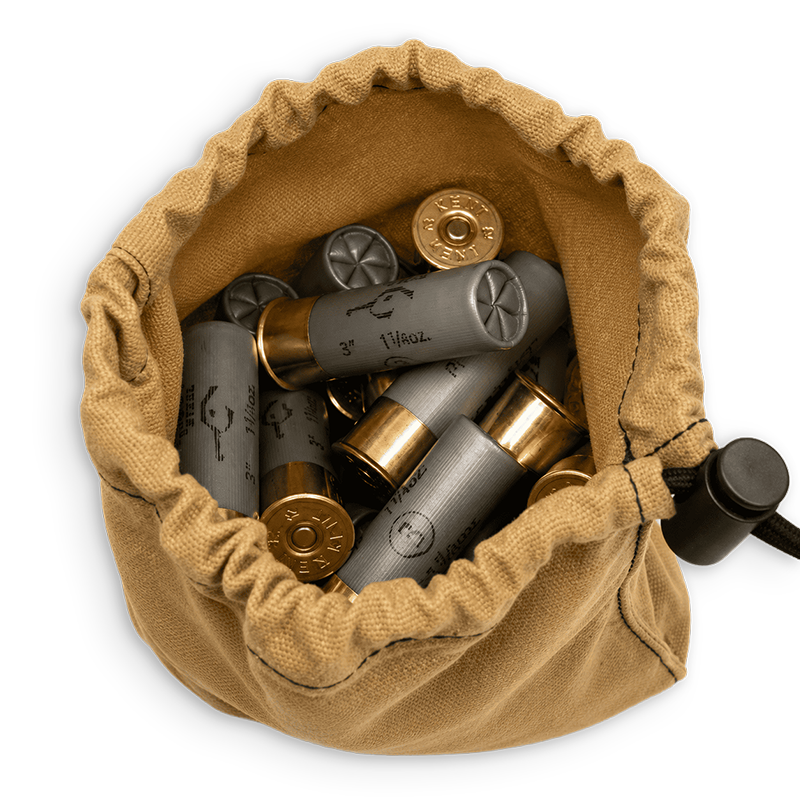 A tan canvas drawstring pouch filled with gray and gold shotgun shells, shown from a top-down view on a white background.