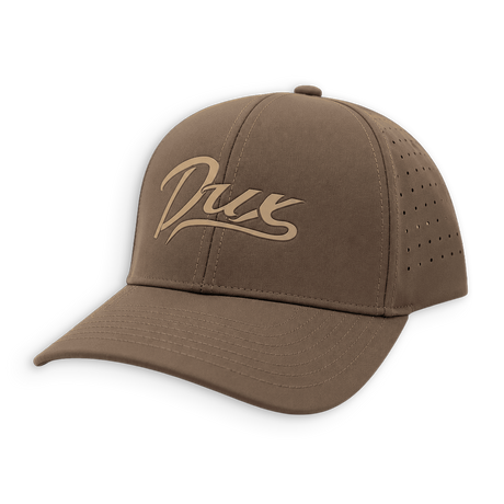 A brown baseball cap with a curved brim, featuring a tan embroidered script logo on the front that reads 'Dux'. The cap has perforated ventilation holes on the side panels and is shown against a plain white background.