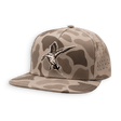 A flat-brim snapback cap in a desert camouflage pattern, featuring a detailed embroidered duck hunting duck on the front panel. The cap has a tan and brown camo pattern with a matching flat brim and perforated side panels.