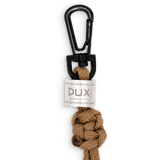 A Dux Bux outdoor knot lanyard with a black carabiner clip and a white brand tag, shown on a plain white background.