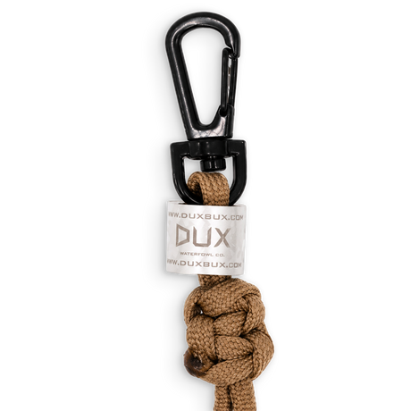 A Dux Bux outdoor knot lanyard with a black carabiner clip and a white brand tag, shown on a plain white background.