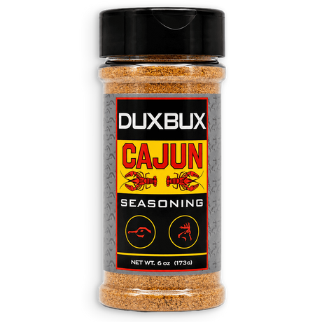 A 6 oz plastic bottle of Duxbux Cajun Seasoning with a black cap and a black, red, and yellow label, shown on a plain white background.