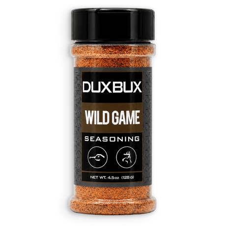 A clear plastic spice jar of DUXBUX Wild Game Seasoning with a black lid and black label, showing orange-brown seasoning inside, on a white background.