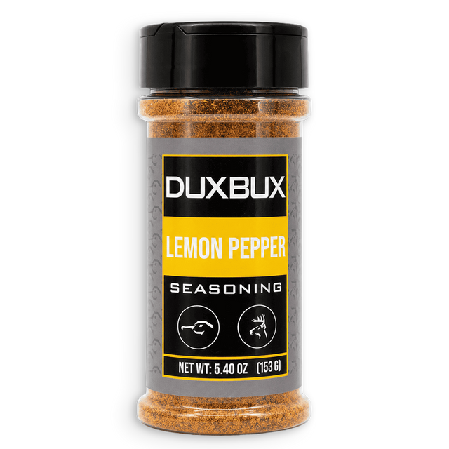 A clear plastic spice jar of Duxbux Lemon Pepper Seasoning with a black lid and a gray, black, and yellow label, set against a plain white background.