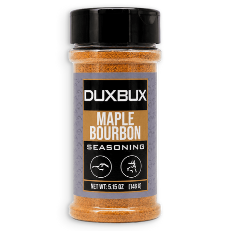 A clear plastic spice jar of Duxbux Maple Bourbon Seasoning with a black lid and a black, gold, and gray label, set against a plain white background.