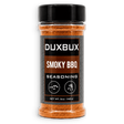 A 5 oz clear plastic bottle of DUXBUX Smoky BBQ Seasoning with a black cap and a black label, showing the orange-brown seasoning inside, on a white background.