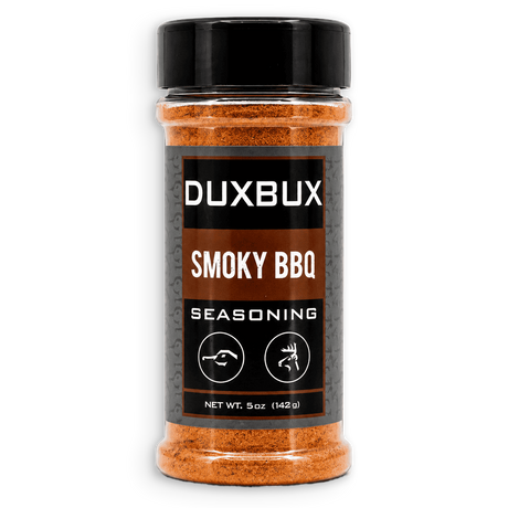 A 5 oz clear plastic bottle of DUXBUX Smoky BBQ Seasoning with a black cap and a black label, showing the orange-brown seasoning inside, on a white background.