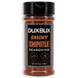 A 5 oz bottle of Duxbux Smoky Chipotle Seasoning, featuring a black cap and a black label with brown and white text, filled with reddish-brown seasoning powder, shown on a white background.