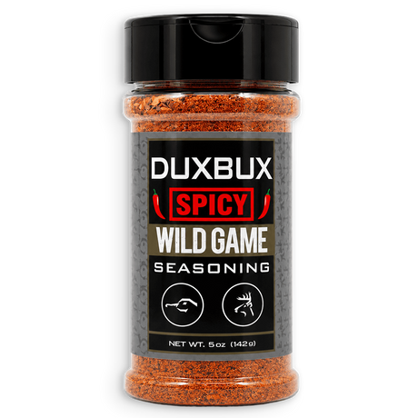A 5 oz clear plastic spice jar of Duxbux Spicy Wild Game Seasoning with a black cap and a black label, filled with orange-red seasoning blend, on a white background.