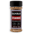 A 6 oz clear plastic bottle of Duxbux Steakhouse Seasoning with a black cap and a gray, red, and black label, shown on a white background.