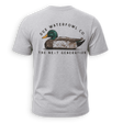 A light gray heather crewneck t-shirt shown from the back, featuring a graphic of a mallard duck with the text 'DUX WATERFOWL CO.' and 'THE NEXT GENERATION'.