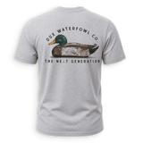 A light gray heather crewneck t-shirt shown from the back, featuring a graphic of a mallard duck with the text 'DUX WATERFOWL CO.' and 'THE NEXT GENERATION'.
